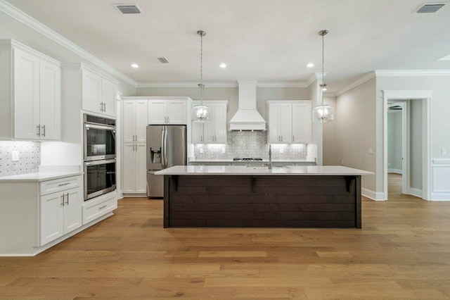 8451 Hickory Branch Trl, Tallahassee, FL 32312 - kitchen with custom exhaust hood, appliances with stainless steel finishes, light wood-type flooring, white cabinetry, and recessed lighting