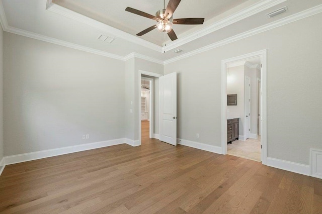 8451 Hickory Branch Trl, Tallahassee, FL 32312 - unfurnished bedroom with a tray ceiling, light wood-style floors, ornamental molding, ceiling fan, and ensuite bath
