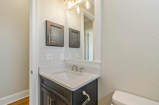 8451 Hickory Branch Trl, Tallahassee, FL 32312 - half bathroom with vanity, wood finished floors, and a textured wall