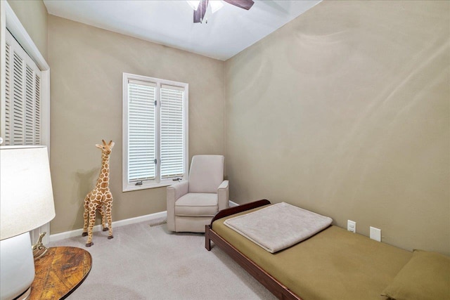 carpeted bedroom featuring baseboards and a ceiling fan