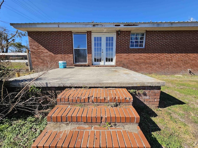 rear view of house featuring french doors, a patio area, and a yard