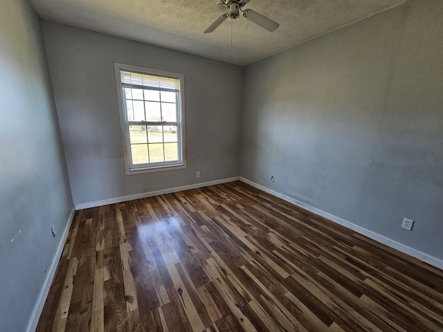 unfurnished room with ceiling fan and dark wood-type flooring