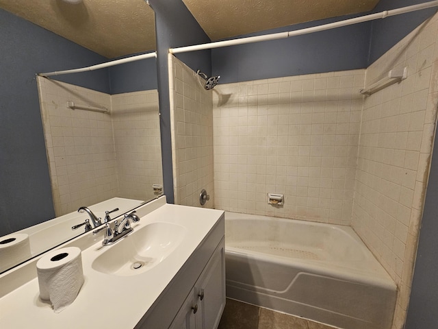 bathroom featuring vanity, tile patterned flooring, bathing tub / shower combination, and a textured ceiling