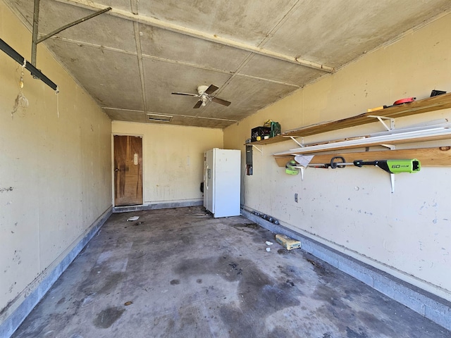 garage with ceiling fan and white refrigerator