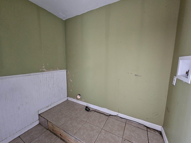 laundry area with light tile patterned floors