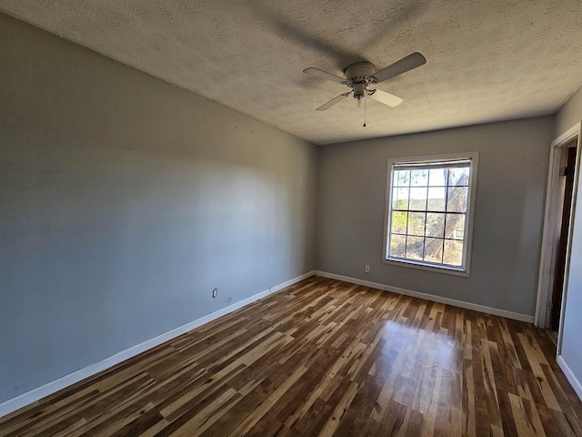 empty room featuring a textured ceiling, ceiling fan, and dark hardwood / wood-style floors