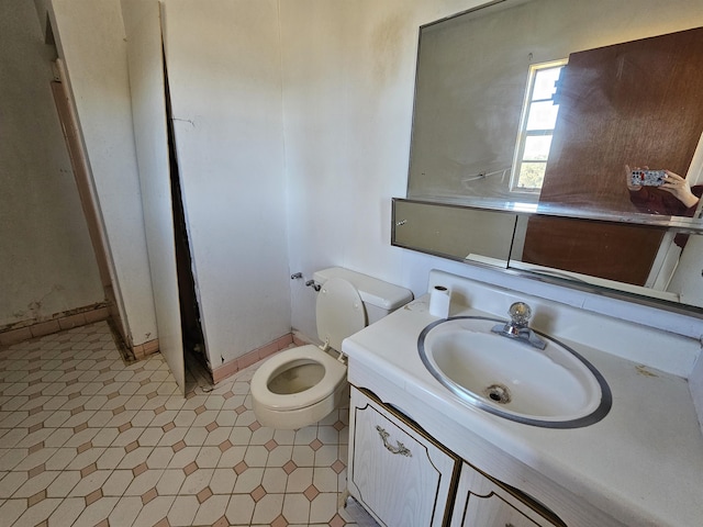 bathroom featuring toilet and vanity