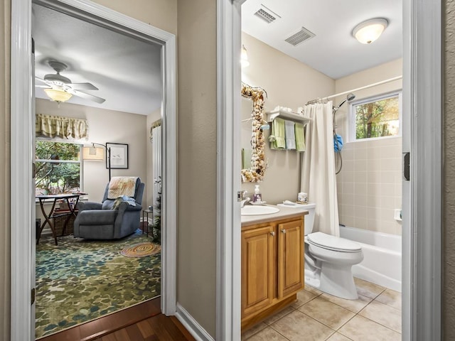 full bathroom with vanity, tile patterned flooring, ceiling fan, toilet, and shower / bathtub combination with curtain