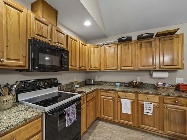 kitchen with white electric range oven, light tile patterned flooring, lofted ceiling, and stone counters