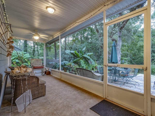 unfurnished sunroom featuring plenty of natural light and ceiling fan