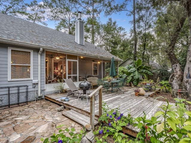 wooden deck with a sunroom