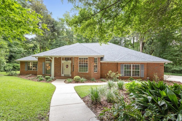 3540 Trillium Ct, Tallahassee, FL 32312 - single story home with a front lawn, a shingled roof, and brick siding