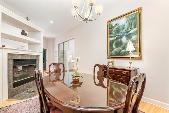 3540 Trillium Ct, Tallahassee, FL 32312 - dining space with a chandelier, wood finished floors, a tile fireplace, and recessed lighting