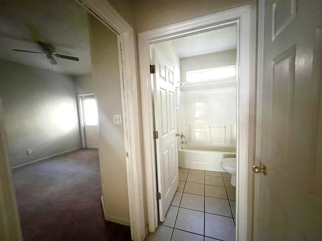 bathroom featuring tile patterned floors, ceiling fan, toilet, and shower / bath combination