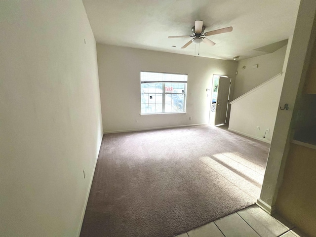 carpeted empty room featuring ceiling fan