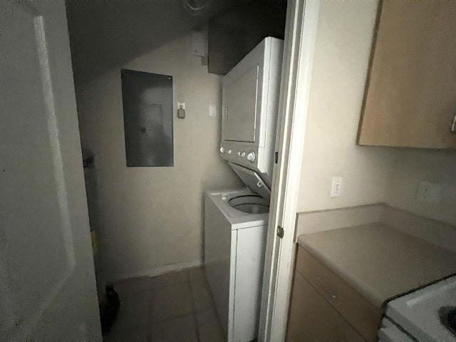 washroom featuring electric panel and stacked washer / dryer