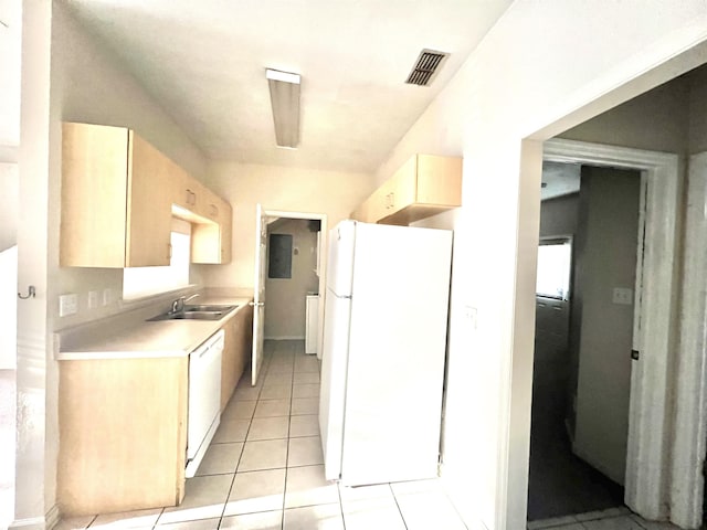 kitchen with light tile patterned flooring, white appliances, and sink