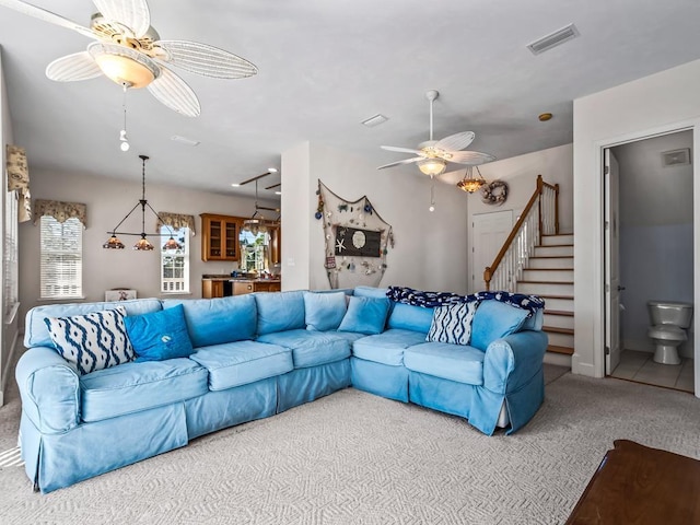 carpeted living room with ceiling fan