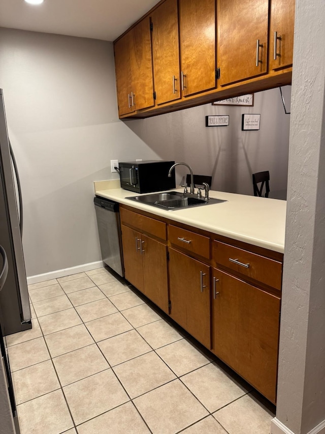 1838 Fernando Ln, Tallahassee, FL 32303 - kitchen with dishwasher, a sink, black microwave, light countertops, and light tile patterned floors