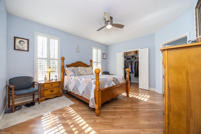 23380 Elmwood Ln, Live Oak, FL 32064 - bedroom featuring light wood-style flooring, a walk in closet, a closet, and a ceiling fan