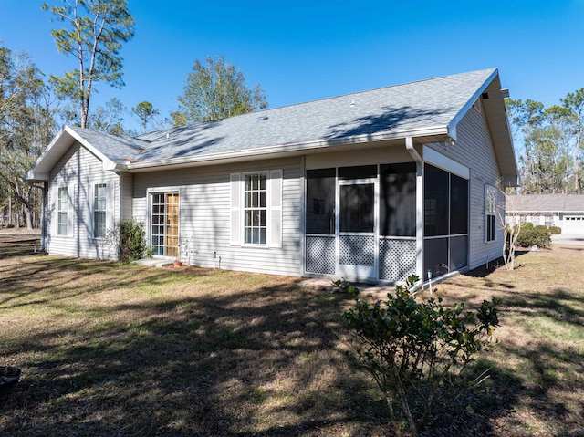 23380 Elmwood Ln, Live Oak, FL 32064 - rear view of property with a sunroom, a yard, and a shingled roof