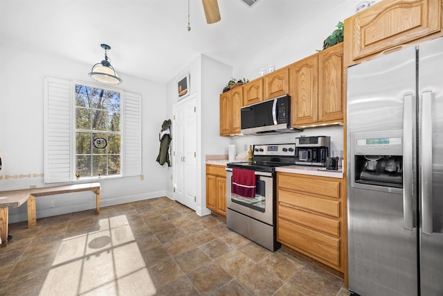 23380 Elmwood Ln, Live Oak, FL 32064 - kitchen with stainless steel appliances, stone finish flooring, light countertops, decorative light fixtures, and ceiling fan