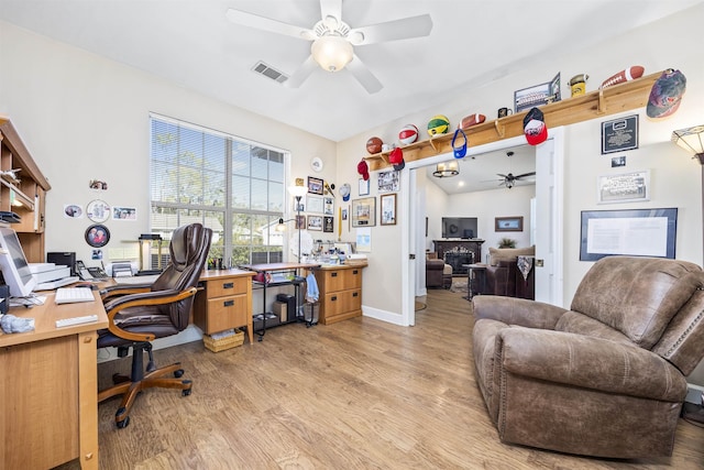 23380 Elmwood Ln, Live Oak, FL 32064 - office area with a ceiling fan, light wood-type flooring, and a fireplace