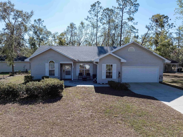 23380 Elmwood Ln, Live Oak, FL 32064 - ranch-style home with an attached garage, driveway, and a shingled roof