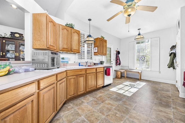 23380 Elmwood Ln, Live Oak, FL 32064 - kitchen featuring stainless steel appliances, light countertops, stone finish floors, decorative light fixtures, and a ceiling fan