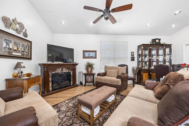 23380 Elmwood Ln, Live Oak, FL 32064 - living room with lofted ceiling, wood finished floors, a ceiling fan, recessed lighting, and a fireplace with raised hearth