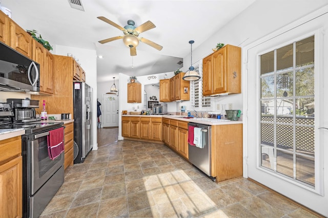 23380 Elmwood Ln, Live Oak, FL 32064 - kitchen with appliances with stainless steel finishes, stone finish flooring, light countertops, a ceiling fan, and lofted ceiling