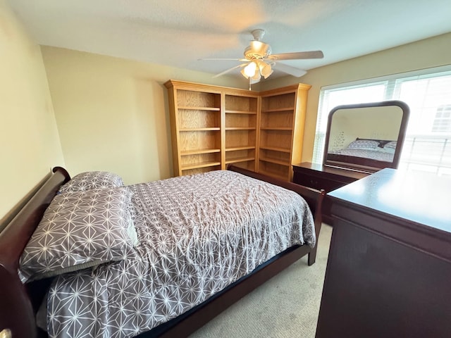 bedroom featuring ceiling fan and carpet