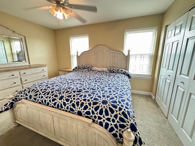 carpeted bedroom with multiple windows, a closet, and ceiling fan