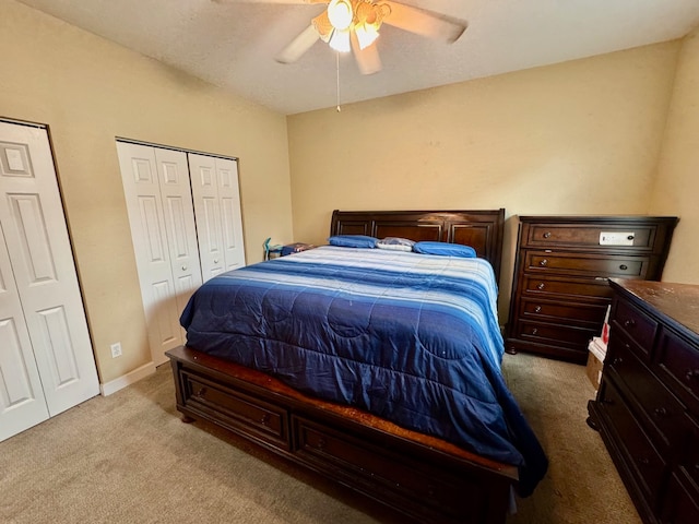 bedroom featuring light colored carpet and ceiling fan