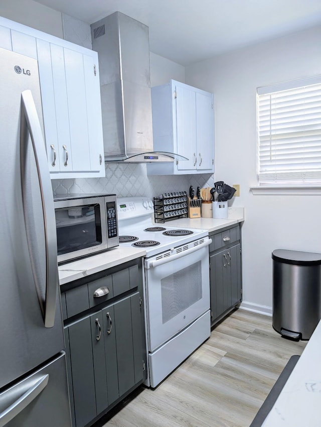 3137 Huttersfield Cir, Tallahassee, FL 32303 - kitchen featuring stainless steel appliances, wall chimney range hood, backsplash, and gray cabinetry