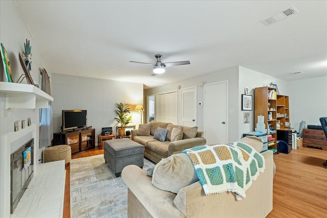 living room featuring ceiling fan and light wood-type flooring