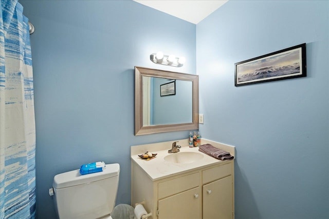 bathroom featuring toilet and vanity