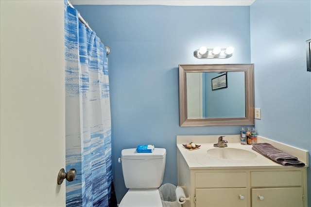 bathroom with toilet, vanity, and a shower with shower curtain