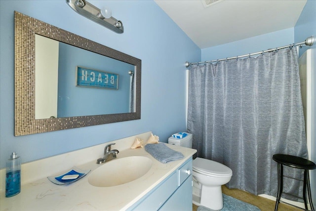 bathroom featuring vanity, toilet, and a shower with curtain