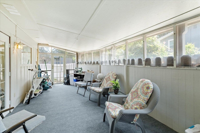 sunroom / solarium featuring a healthy amount of sunlight and vaulted ceiling