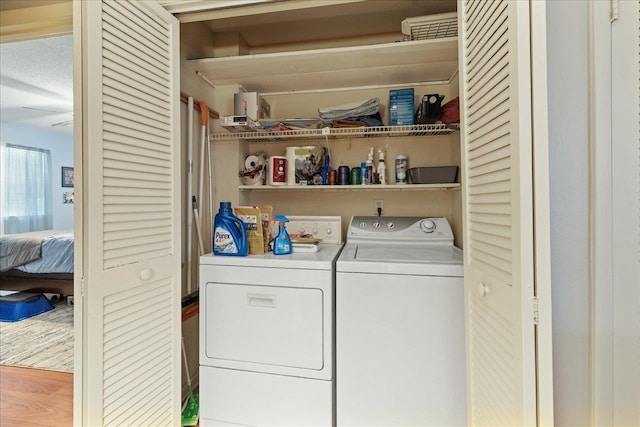 washroom featuring hardwood / wood-style floors and washer and dryer