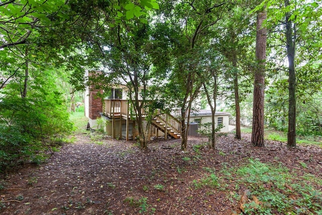 view of yard featuring stairway and a wooden deck