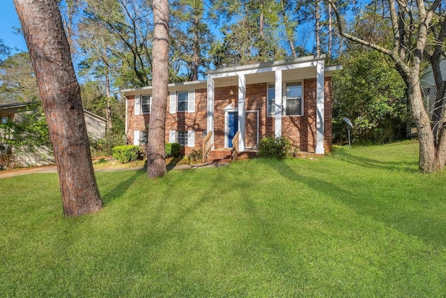 view of front of home with brick siding and a front lawn