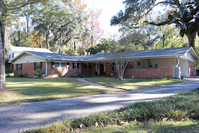 ranch-style house with a front yard and a carport