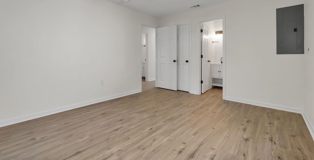 1115 Joe Louis St, Tallahassee, FL 32304 - unfurnished bedroom featuring electric panel, light wood-style flooring, and ensuite bathroom