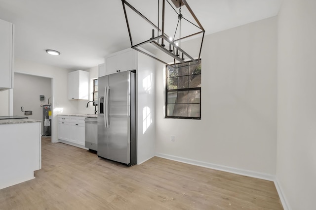 1115 Joe Louis St, Tallahassee, FL 32304 - kitchen featuring stainless steel appliances, white cabinets, water heater, light wood-style floors, and hanging light fixtures