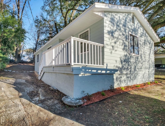 view of side of home featuring a balcony