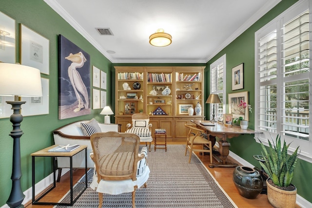 sitting room featuring crown molding and wood-type flooring