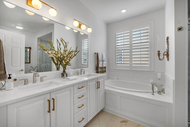 bathroom with vanity and a washtub