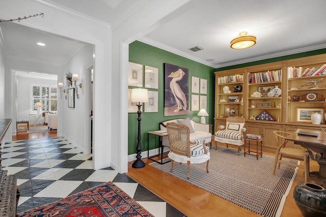 living area featuring crown molding and hardwood / wood-style floors